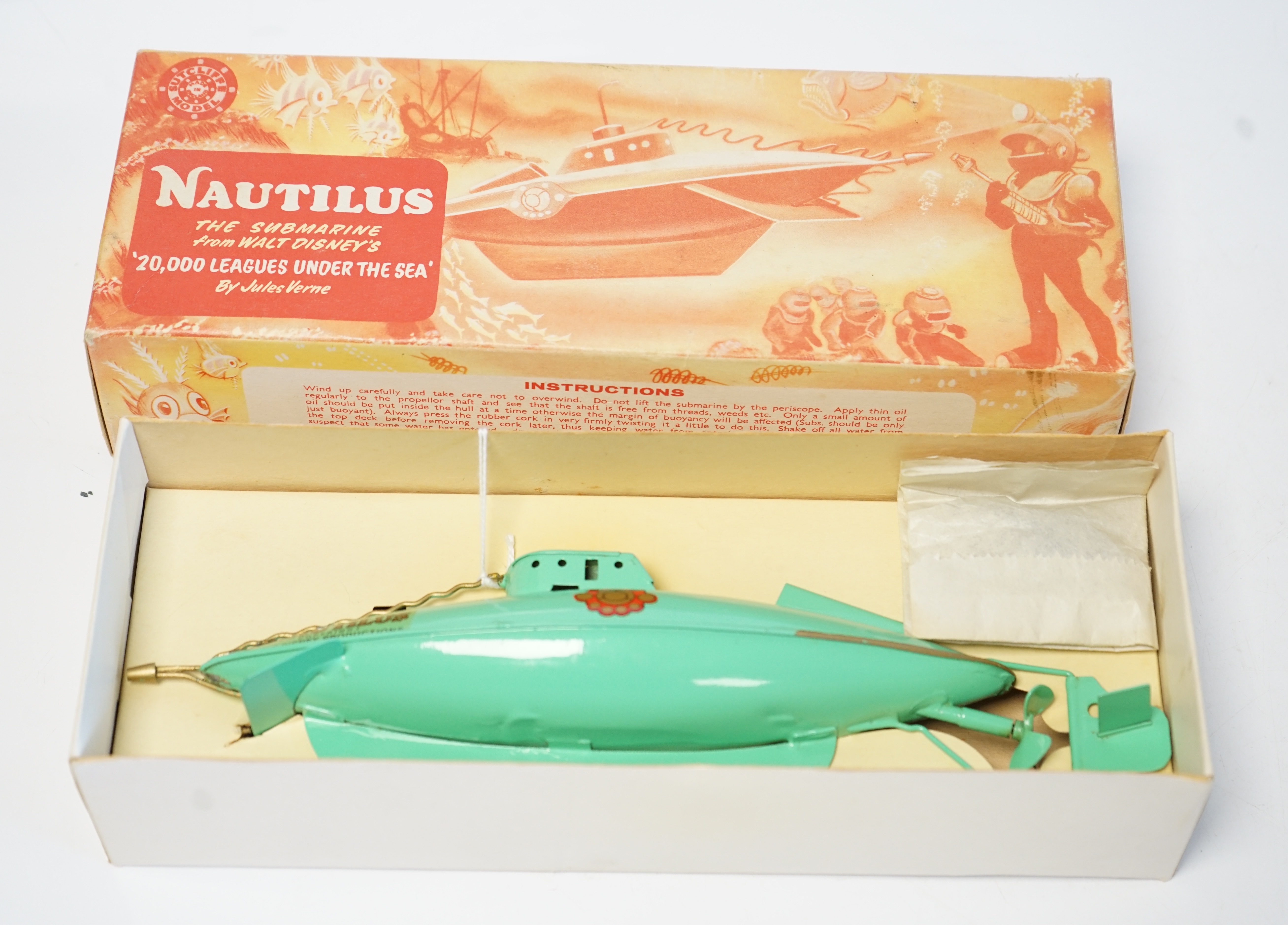 A Sutcliffe Models Nautilus clockwork tinplate submarine modelled on Walt Disney’s 20,000 Leagues Under the Sea, boxed with inner packing card piece. Condition - good, a fine example